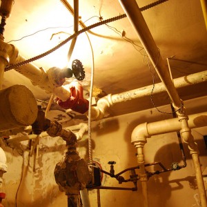 A complex arrangement of rigid steel piping and stop valves regulate flow to various parts of the building